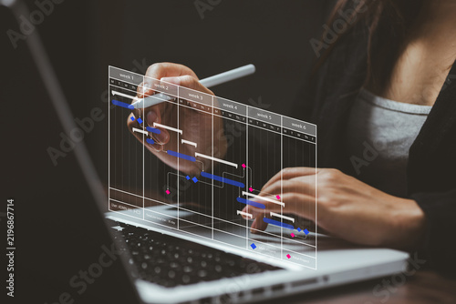 Businesswoman using a laptop with a digital project timeline and Gantt chart, representing project management, scheduling, workflow planning, deadlines, teamwork, and business productivity.