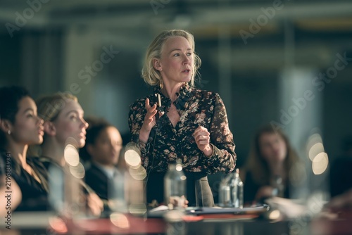Middle aged businesswoman speaking passionately during a corporate conference meeting