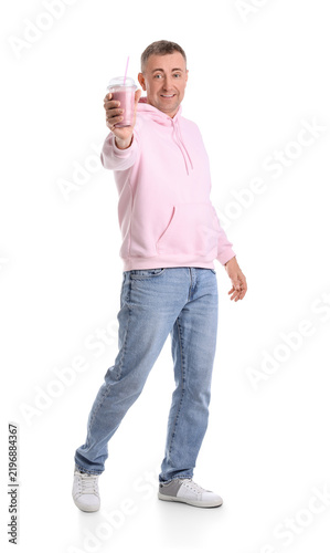 Mature man with glass of fruit smoothie on white background