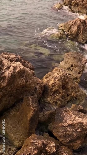 Rugged Coastal Rocks and Clear Blue Sea in Natural Daylight