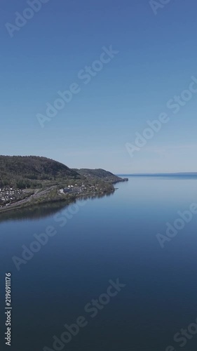Calm Coastal Bay Surrounded by Rocky Hills Under a Clear Blue Sky