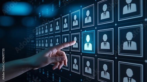 Hand pointing at a digital grid of profile representing human resources management and corporate recruitment software systems