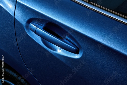 Close-up of a Modern Blue Car Door Handle and Body Panel.