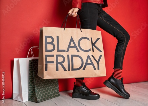 black friday shopping sale with paper bags on red background