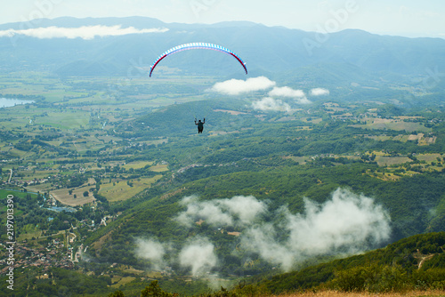 paraglider over the green mountains
