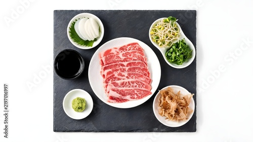 Sliced raw beef with accompaniments
