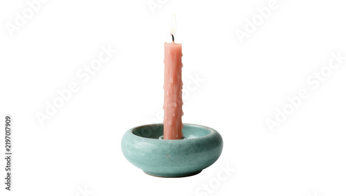 Fotografie Pink drippy candle burning in a teal ceramic holder, isolated on transparent bac