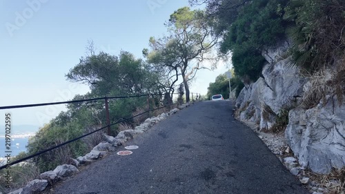 Narrow asphalt mountain road along a rocky cliff in Gibraltar