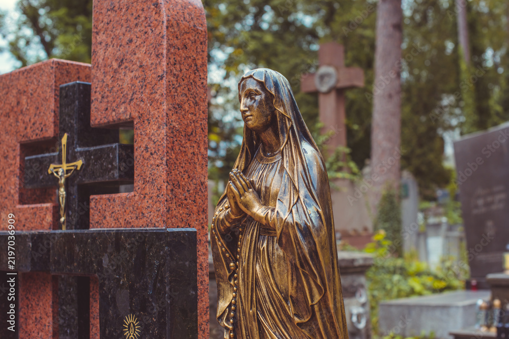 Fototapeta premium Ancient European cemetery with stone angels and historic tombstones
