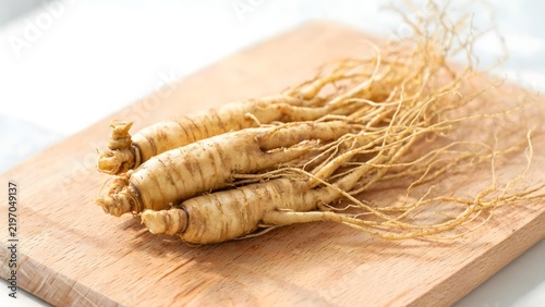 Ginseng roots on wooden cutting board