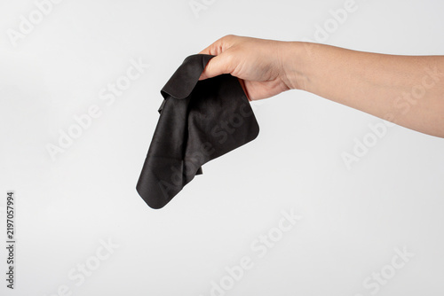 Fotografie Chamois cloth for cleaning cameras, mobile phones, and computer screens, held against a white background