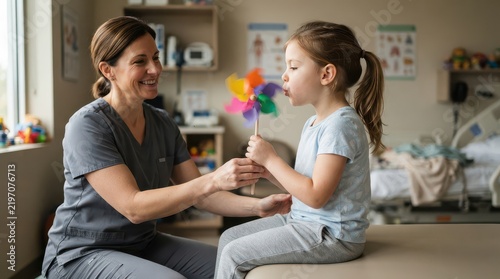 Nurse assisting a girl blowing a colorful pinwheel on an examination table