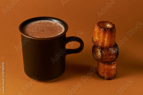 Hot Chocolate in Dark Mug with Canelé Pastry