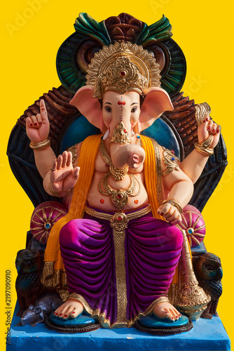 Obraz na plátně indian god ganesh or ganapati state sitting on throne with yellow background