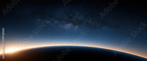 Horizon glow on planet's curve beneath a starry galaxy