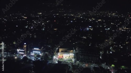 Aerial night view of illuminated buildings and city streets in New Delhi India