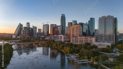 Aerial view of downtown Austin skyline with green park and river at dusk, Texas