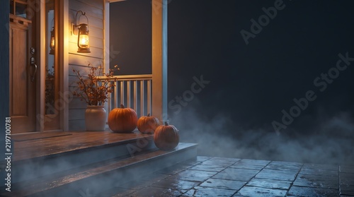 Three decorative pumpkins on a cozy porch at night with warm lamp lighting