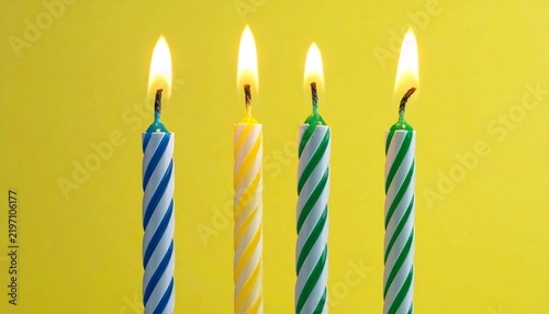 Three Spiral Birthday Candles Isolated yellow background
