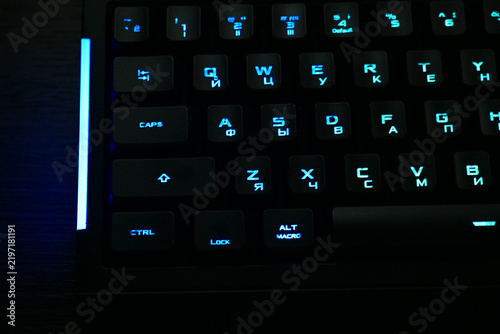 Konstfotografi black gaming mechanical keyboard with blue led backlight close up, illuminated c