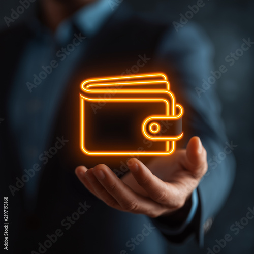 Glowing orange neon wallet icon floating above businessman open hand, digital finance and e-wallet concept.