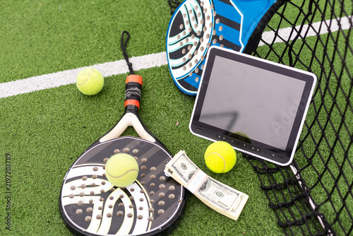Cuadro en lienzo Two paddle tennis rackets and balls on artificial grass. tablet