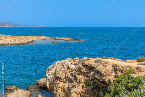 Scenic cove at Agii Apostoli beach near Chania in Crete, Greece, featuring calm turquoise sea and sandy beach in summer.