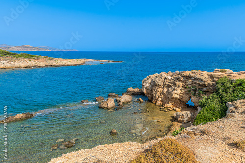 Scenic cove at Agii Apostoli beach near Chania in Crete, Greece, featuring calm turquoise sea and sandy beach in summer.