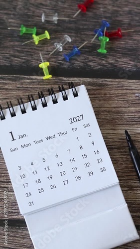 2027 calendar on a wooden desk. Vertical video. New year plan, goals, and resolutions concept.