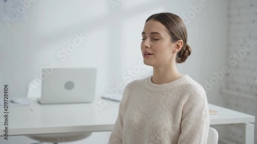 A young woman with her eyes closed, appearing to be meditating or deep in thought.