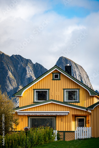 Traditional yellow wooden house in Norway landscape