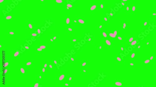 Pink confetti particles scattered on bright green background