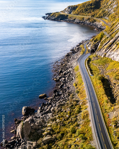 Scenic coastal road winding along a dramatic fjord