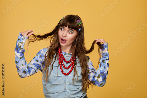 Принти на полотні Stylish woman expresses joy in vibrant colors and playful hairstyle