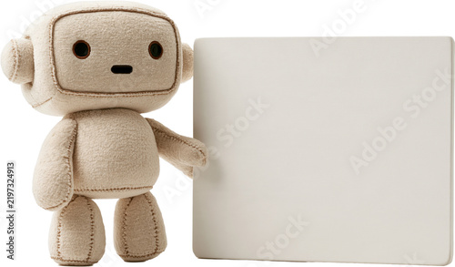 Small plush robot beside signboard