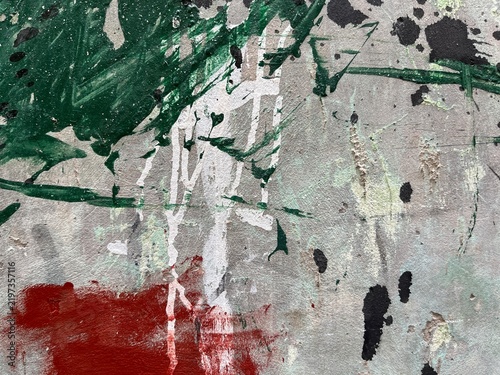 Abstract paint strokes in green, white, and red. Bold brushstrokes swirl across textured canvas surface. Red smear contrasts with vibrant green splatters and white streaks