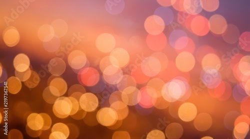Warm golden bokeh lights with soft colorful blur evening background