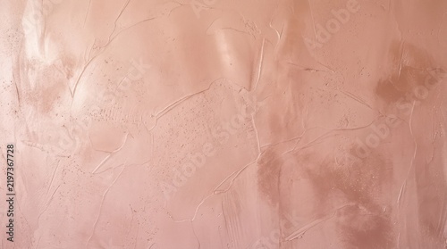 Soft pink textured wall with subtle cracks and natural concrete patterns