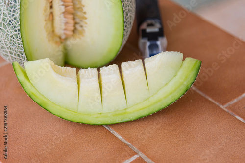 Fresh green melon on wood plate