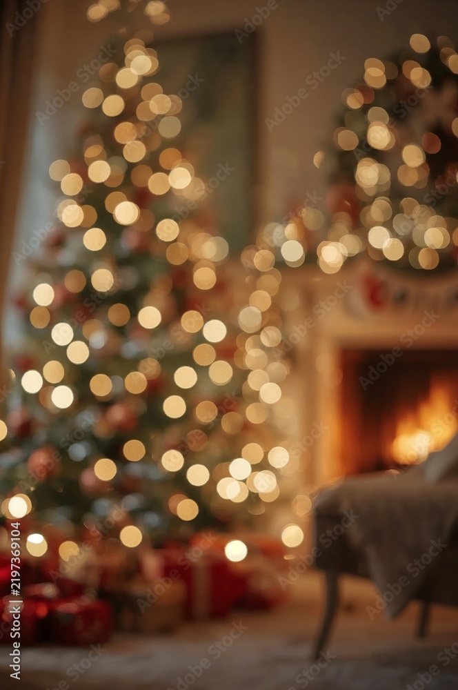 Obraz premium Christmas Decorations With Blurred Lights and a Warm Fireplace in a Cozy Living Room