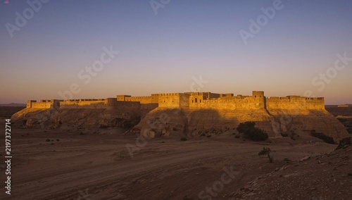 Old Fort Stands on a Hill During Sunset in a Desert Landscape