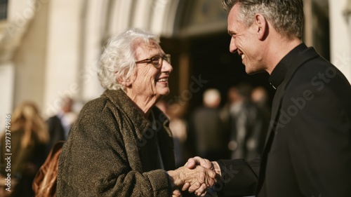 Pastor Warmly Greeting Elderly Congregant Outside Church After Sunday Service, Pastor Appreciation Sunday Concept