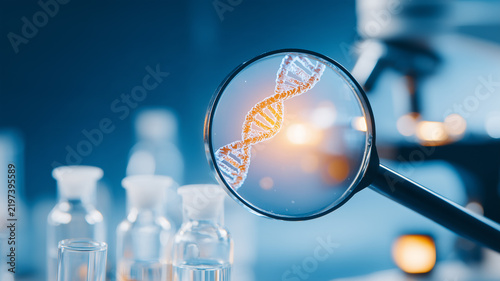 A magnifying glass examines a DNA helix in a laboratory representing genetic research biotechnology and molecular analysis.
