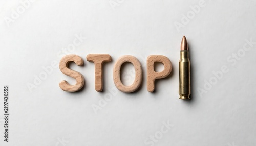 Wooden stop letters with bullet cartridge anti war and gun violence control concept.