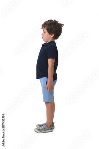 side view of a boy dressed in summer clothes on white background (6 year old)