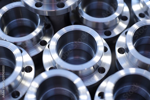 Metal flanges wait in a production line for assembly.
