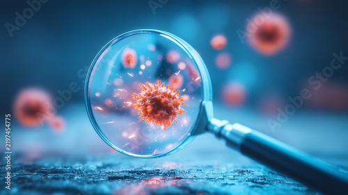 A magnifying glass examining a virus particle representing infection detection and medical laboratory analysis.
