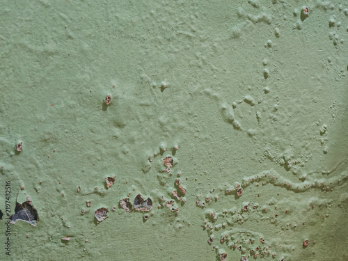 blistered and peeling green paint on a weathered wall surface. Target: abstract textural backgrounds, urban decay concepts, and architectural renovation templates