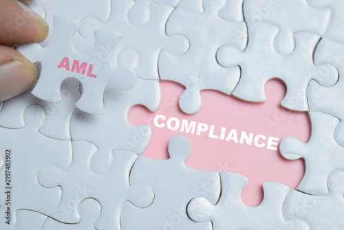Piece of jigsaw puzzle AML compliance phrase. AML - Anti Money Laundering