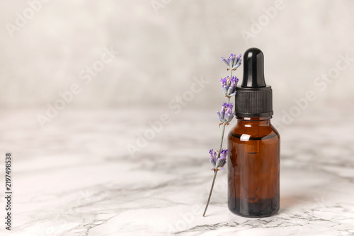 Lavender essential oil in glass and bottles with fresh lavender fowers. Natural aromatherapy. Organic skincare. Herbal cosmetic serum. Spa wellness treatment. Botanical Extract, beauty and self care 